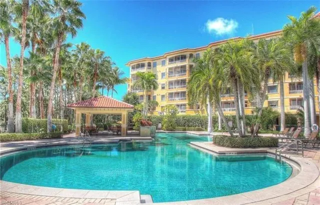 a swimming pool with outdoor seating and yard
