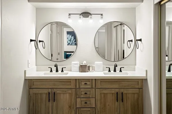 a bathroom with a double vanity sink and a mirror