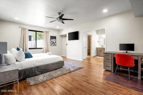 a bedroom with a bed and wooden floor