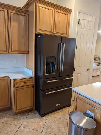 a kitchen with stainless steel appliances granite countertop a refrigerator and a stove
