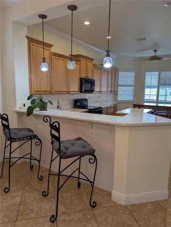 a kitchen with stainless steel appliances granite countertop a sink and a stove