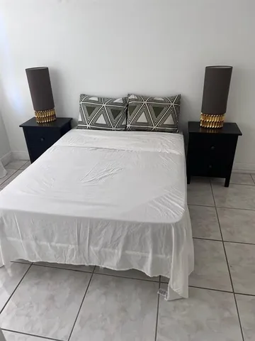 a bedroom with a bed and chair