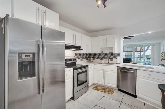 a kitchen with cabinets stainless steel appliances and a counter top space
