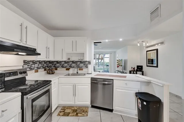a kitchen with a sink stove and cabinets