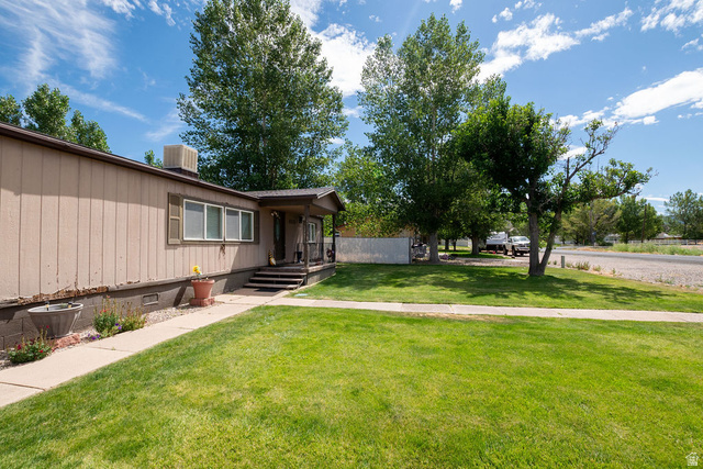855 East 300 N Street Beaver, UT 84713 - Photo 4 of 44 Well-maintained front lawn and walkway leading to a covered porch entrance