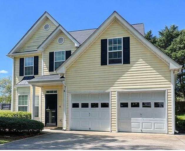 a view of a house with a yard and potted plants