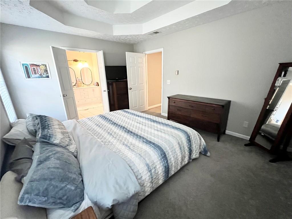 225 Lee Court Canton, GA 30115 - Photo 14 of 18 a bedroom with a bed and wooden floor