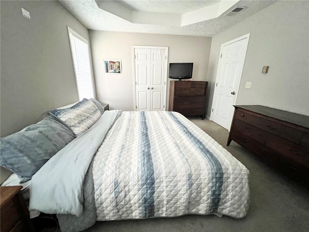 225 Lee Court Canton, GA 30115 - Photo 15 of 18 a bedroom with a bed and a television