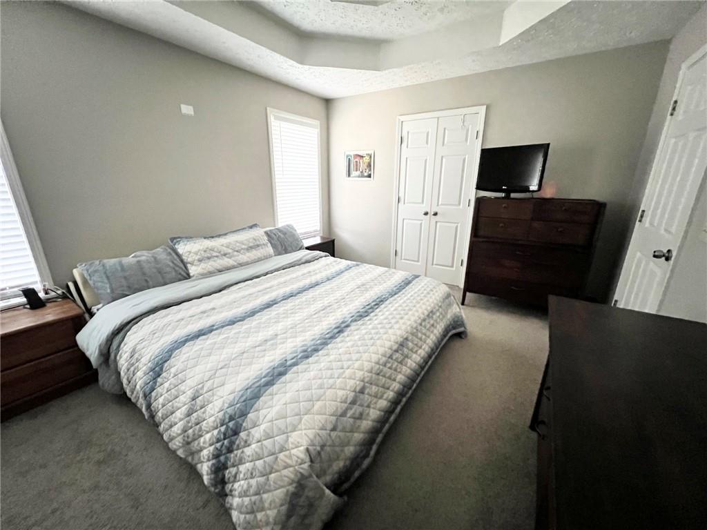 225 Lee Court Canton, GA 30115 - Photo 16 of 18 a bedroom with a bed and a television