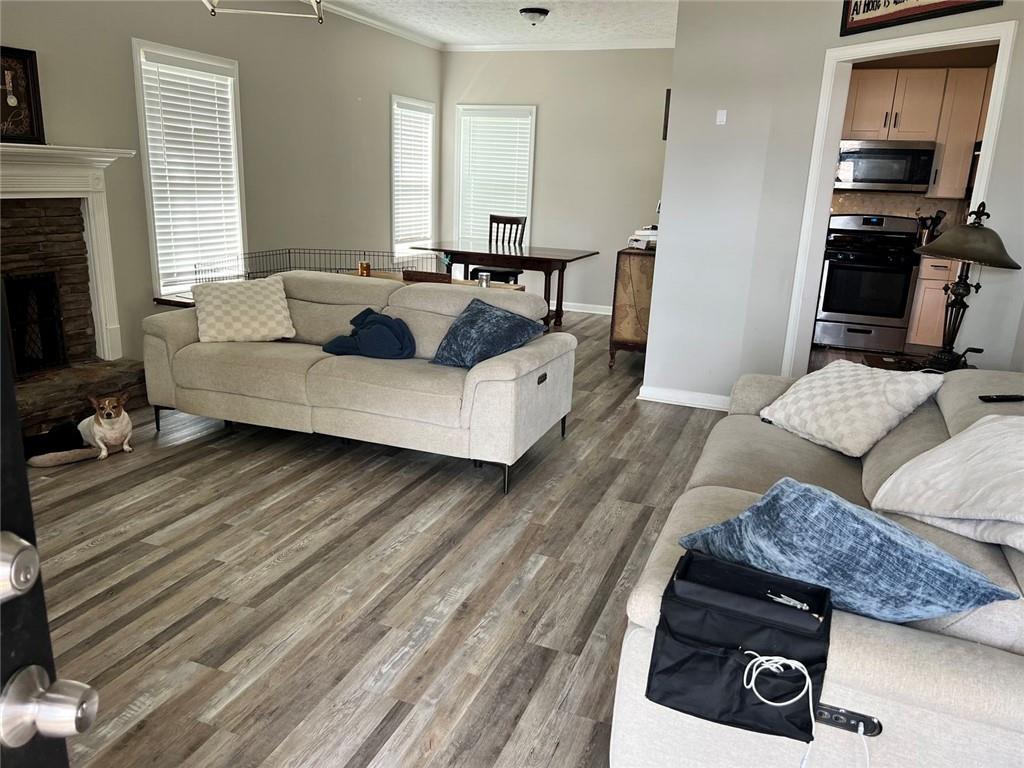 225 Lee Court Canton, GA 30115 - Photo 6 of 18 a living room with furniture and a flat screen tv