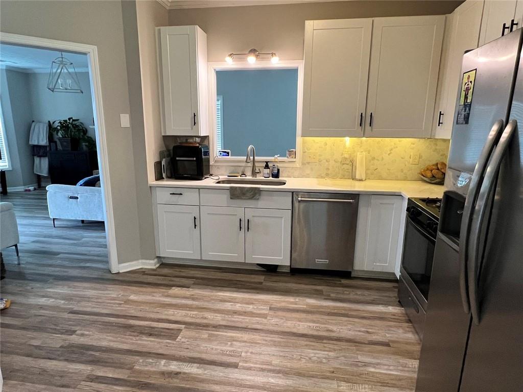 225 Lee Court Canton, GA 30115 - Photo 7 of 18 a kitchen with stainless steel appliances a sink stove and refrigerator