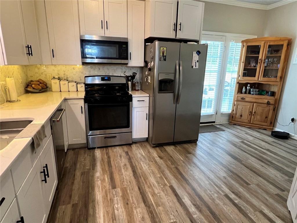 225 Lee Court Canton, GA 30115 - Photo 8 of 18 a kitchen with stainless steel appliances granite countertop a refrigerator stove and sink