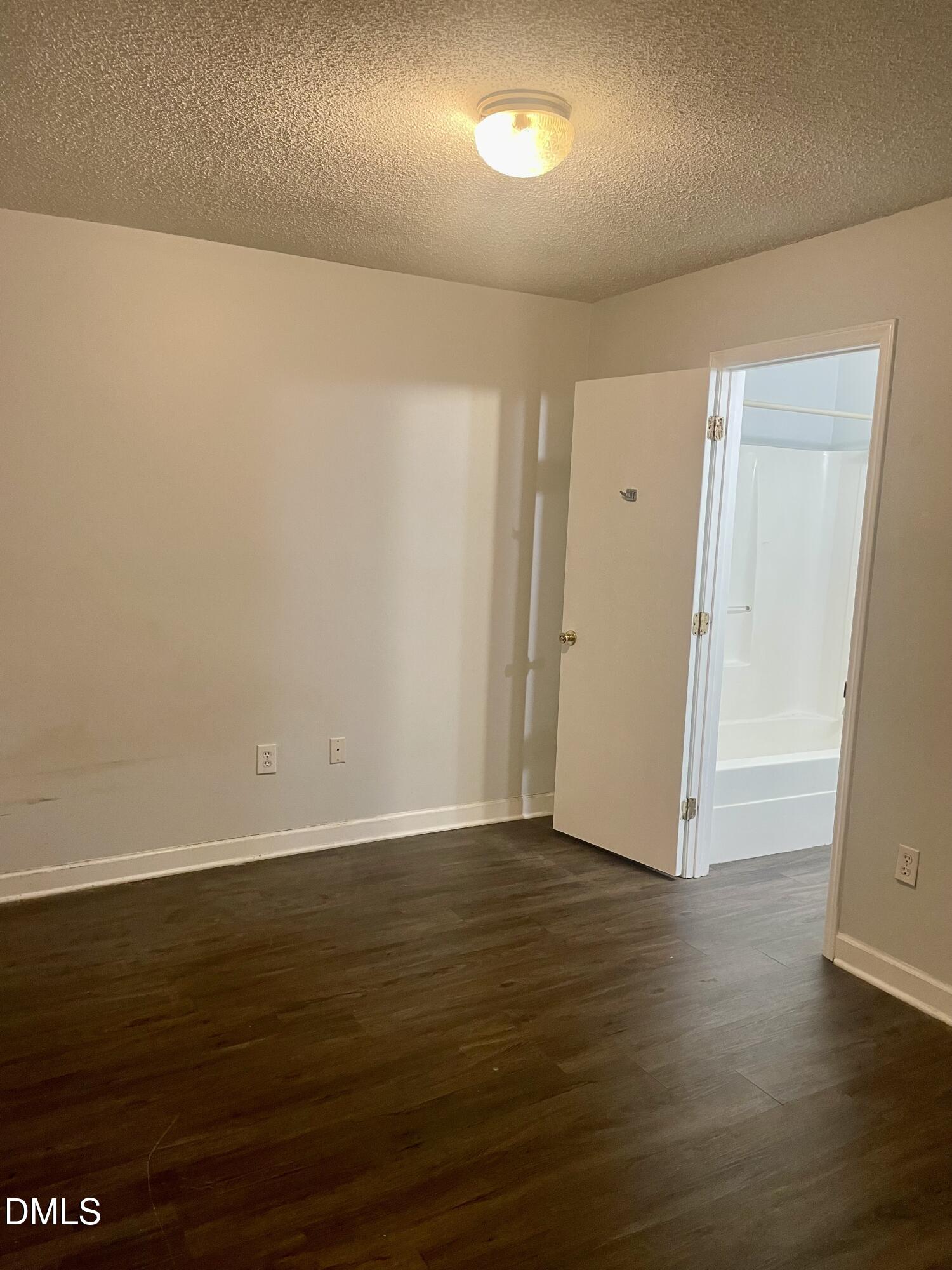 303 Smith Level Road, Unit C12 Chapel Hill, NC 27516 - Photo 12 of 18 an empty room with wooden floor and windows