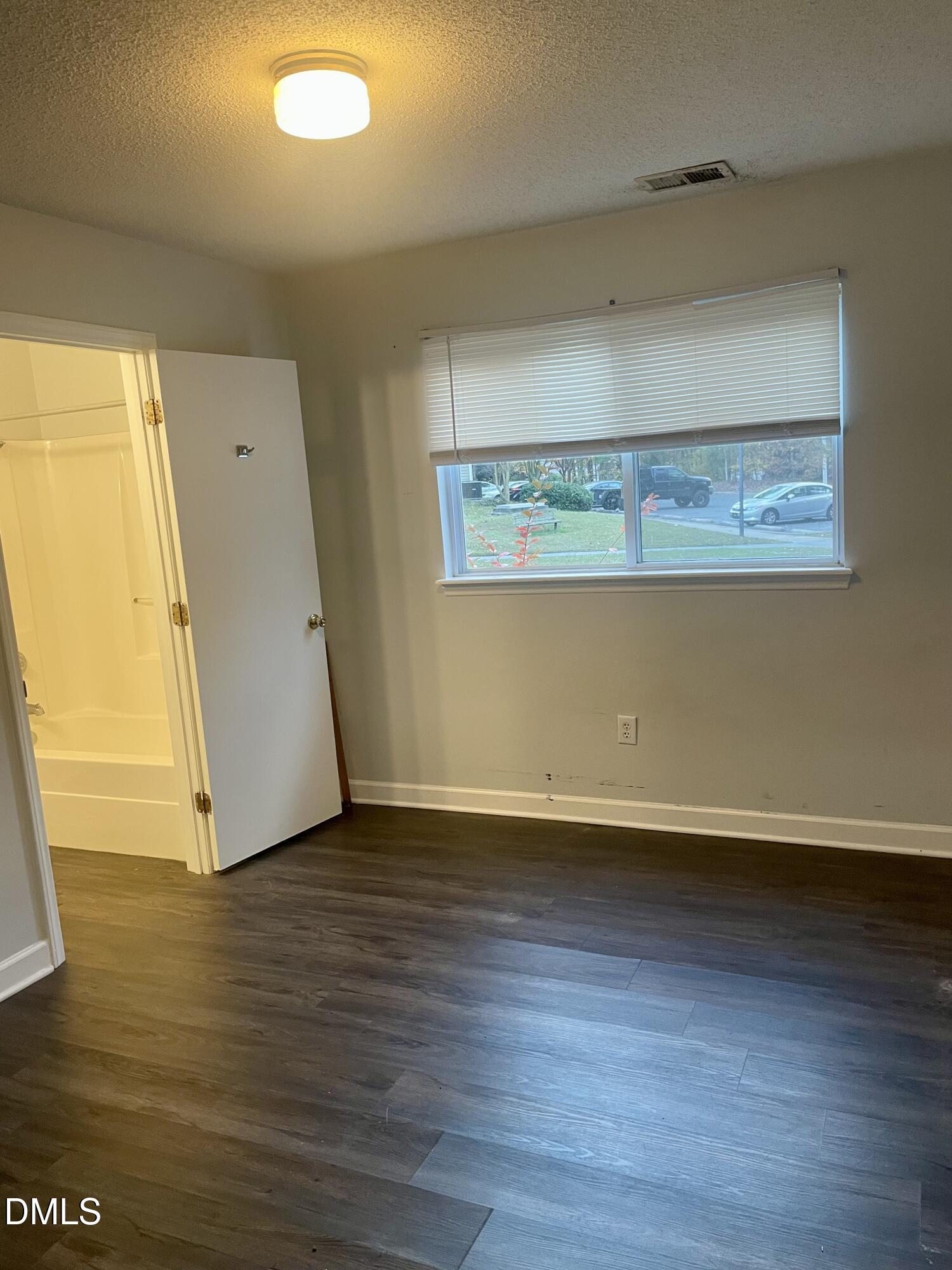 303 Smith Level Road, Unit C12 Chapel Hill, NC 27516 - Photo 10 of 18 an empty room with wooden floor