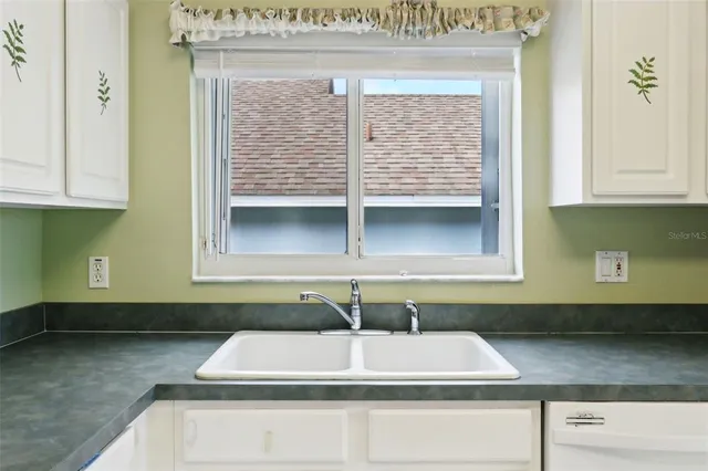 a kitchen with a sink and cabinets