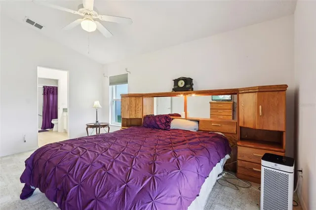 a bedroom with a large bed and a window