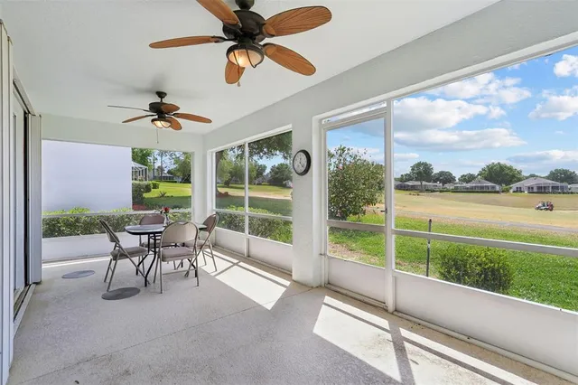 a view of a porch with furniture and a yard
