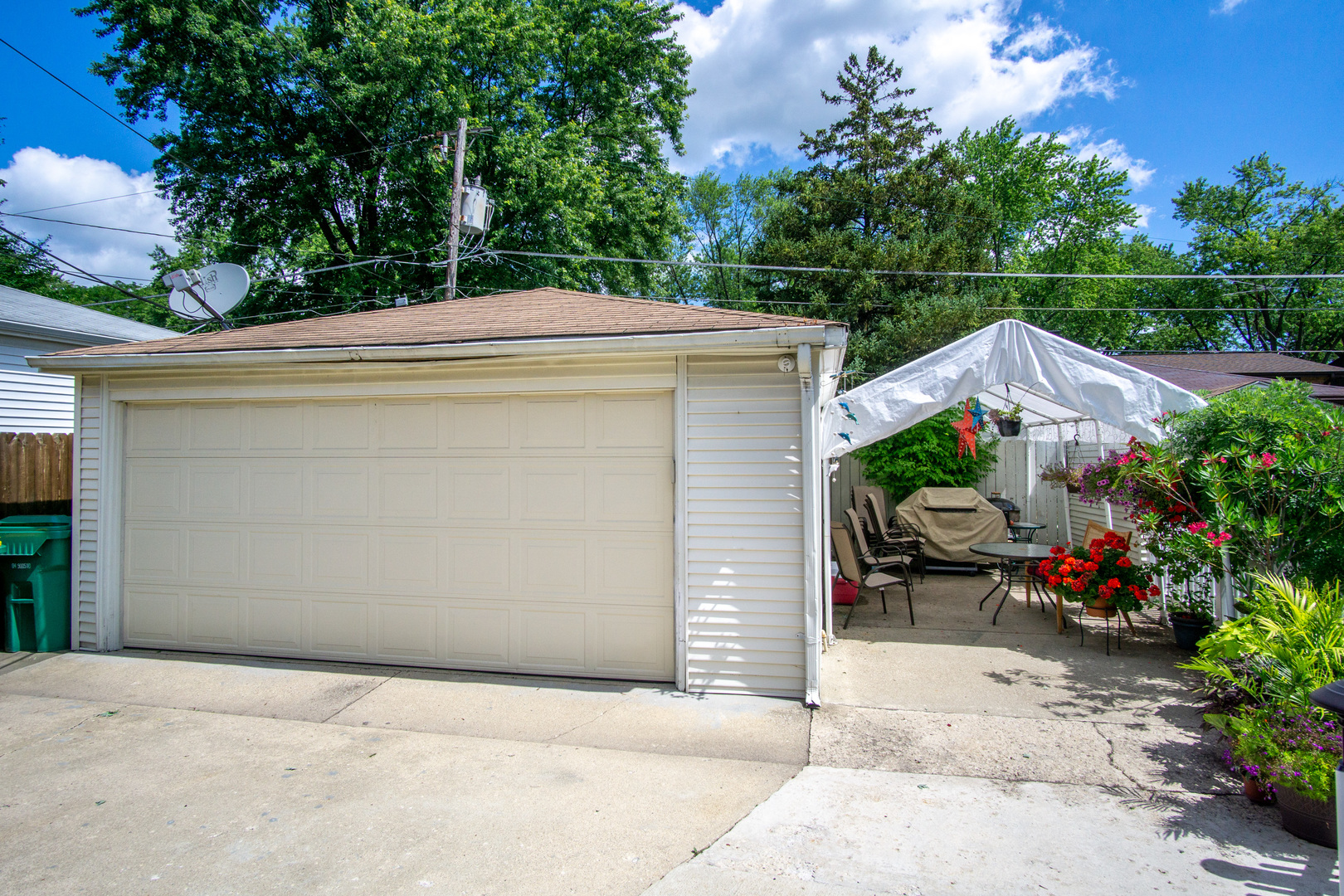 385 South Wolf Road Wheeling, IL 60090 - Photo 13 of 14 a backyard of a house with potted plants and a garage