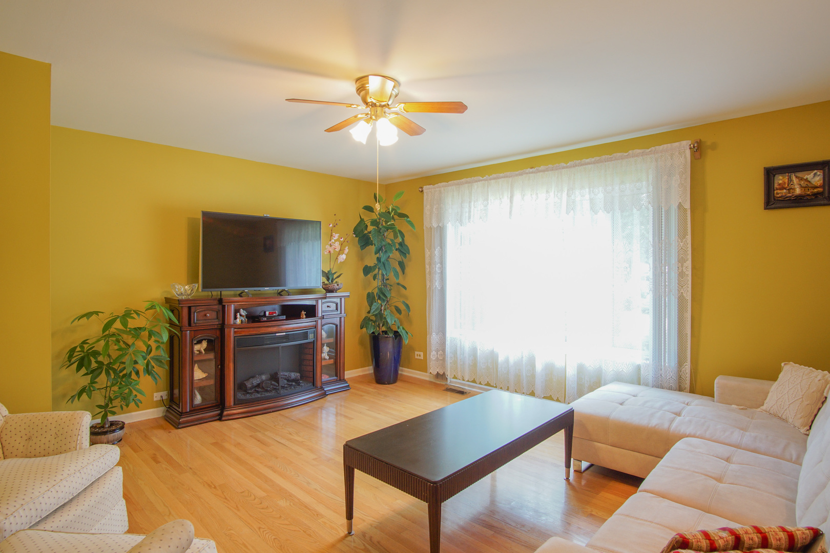 385 South Wolf Road Wheeling, IL 60090 - Photo 3 of 14 a living room with furniture and a flat screen tv
