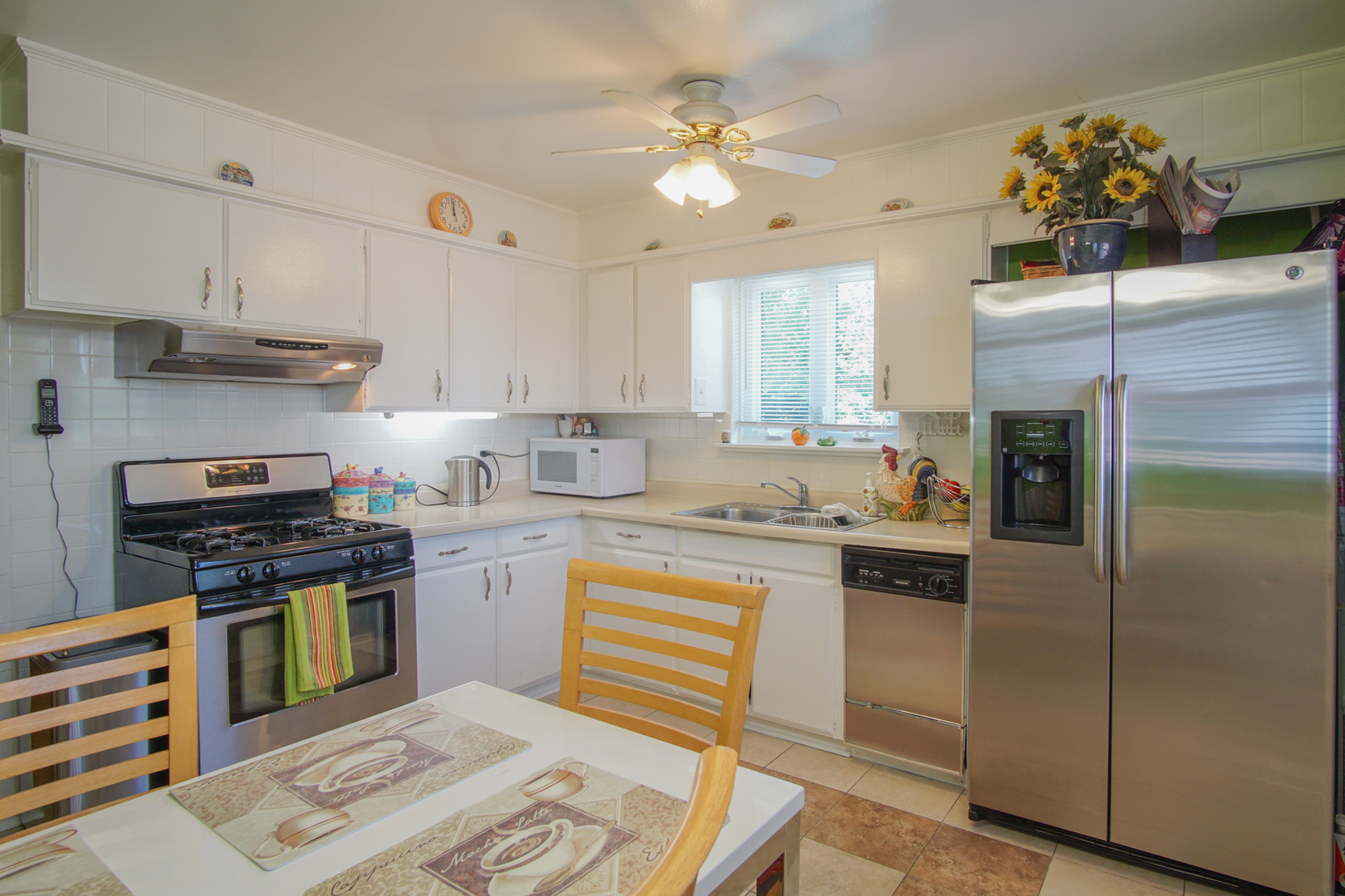385 South Wolf Road Wheeling, IL 60090 - Photo 4 of 14 a kitchen with a stove a sink and a refrigerator
