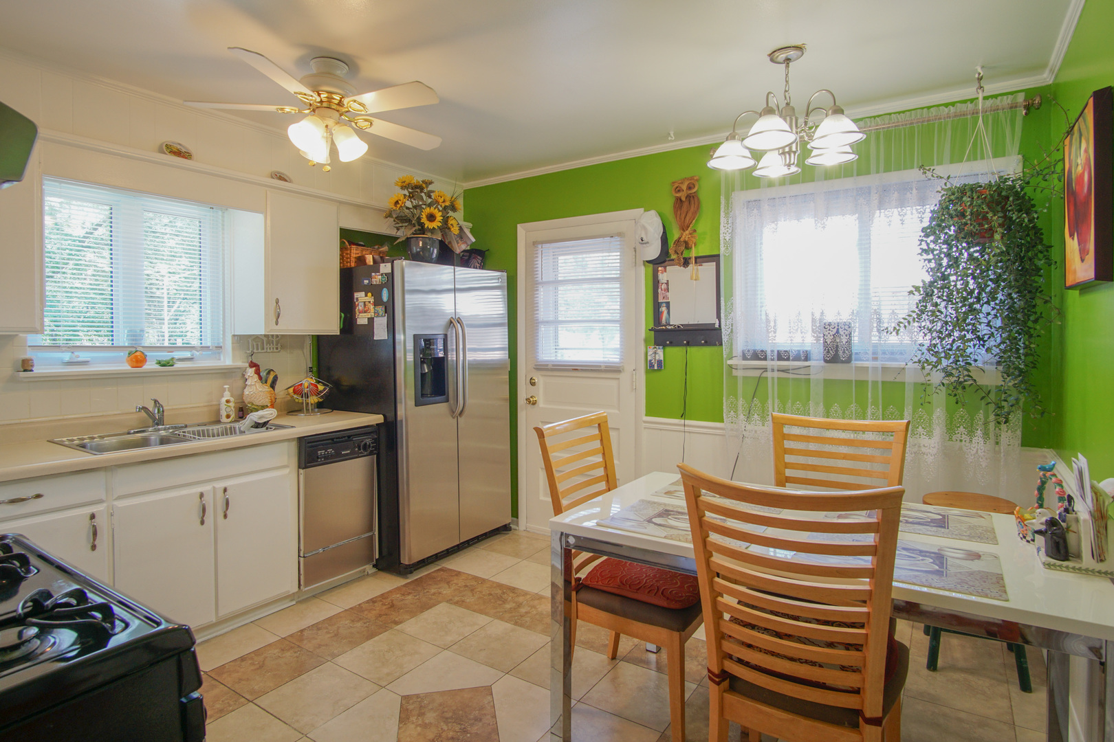 385 South Wolf Road Wheeling, IL 60090 - Photo 5 of 14 a very nice looking dining room with a kitchen island furniture and a chandelier