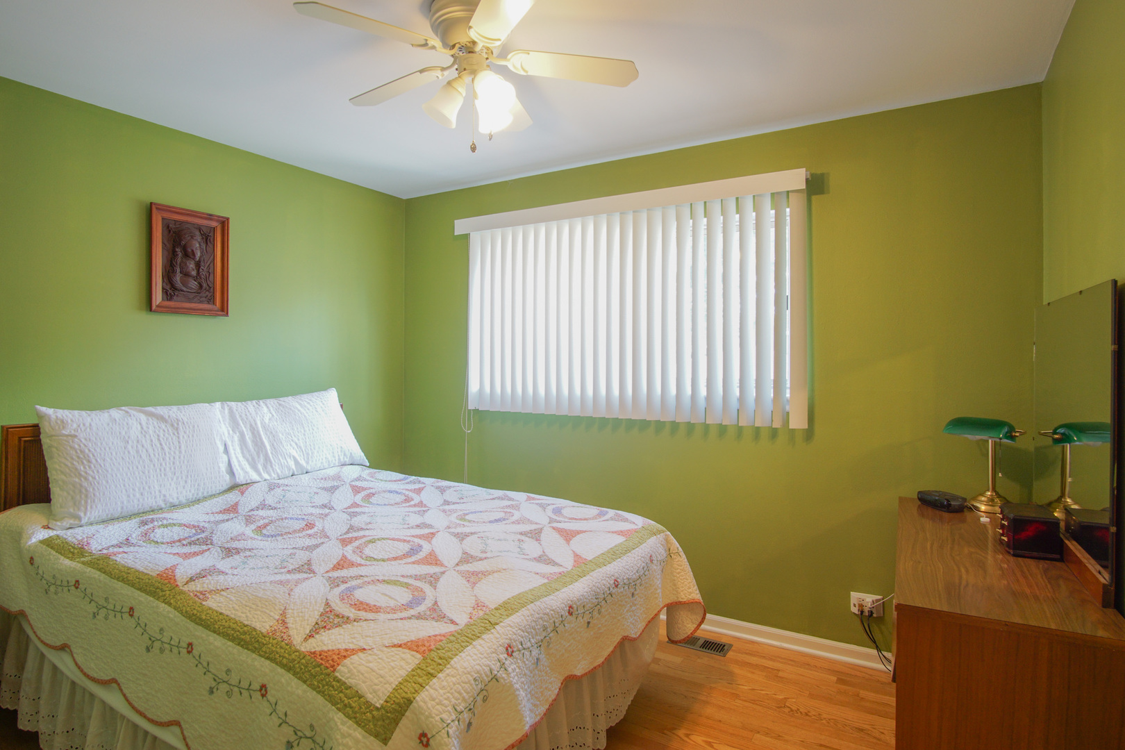 385 South Wolf Road Wheeling, IL 60090 - Photo 6 of 14 a bedroom with a bed and a chandelier