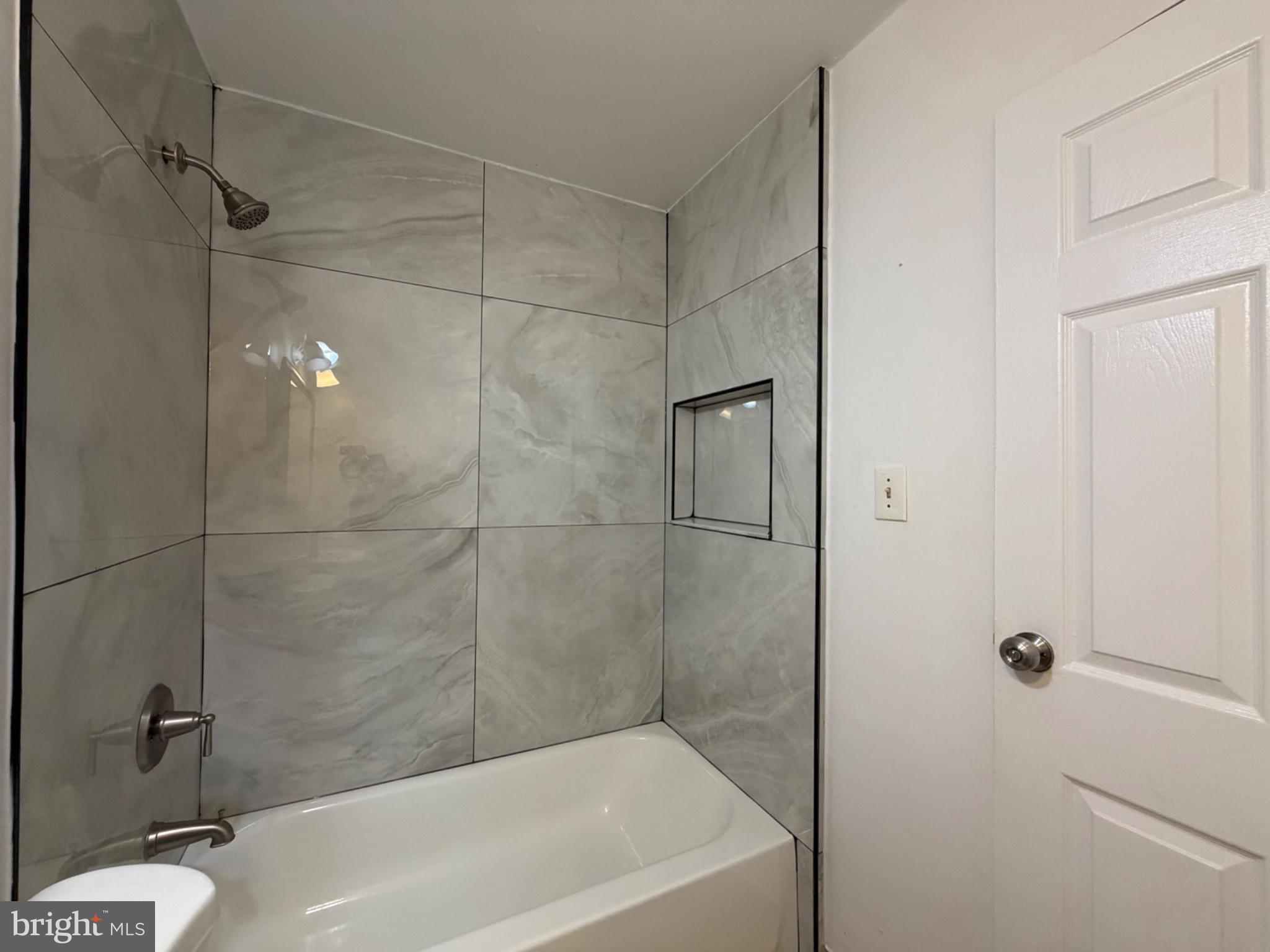 606 West Beech Road Sterling, VA 20164 - Photo 27 of 33 Hall bathroom with sleek tiles.