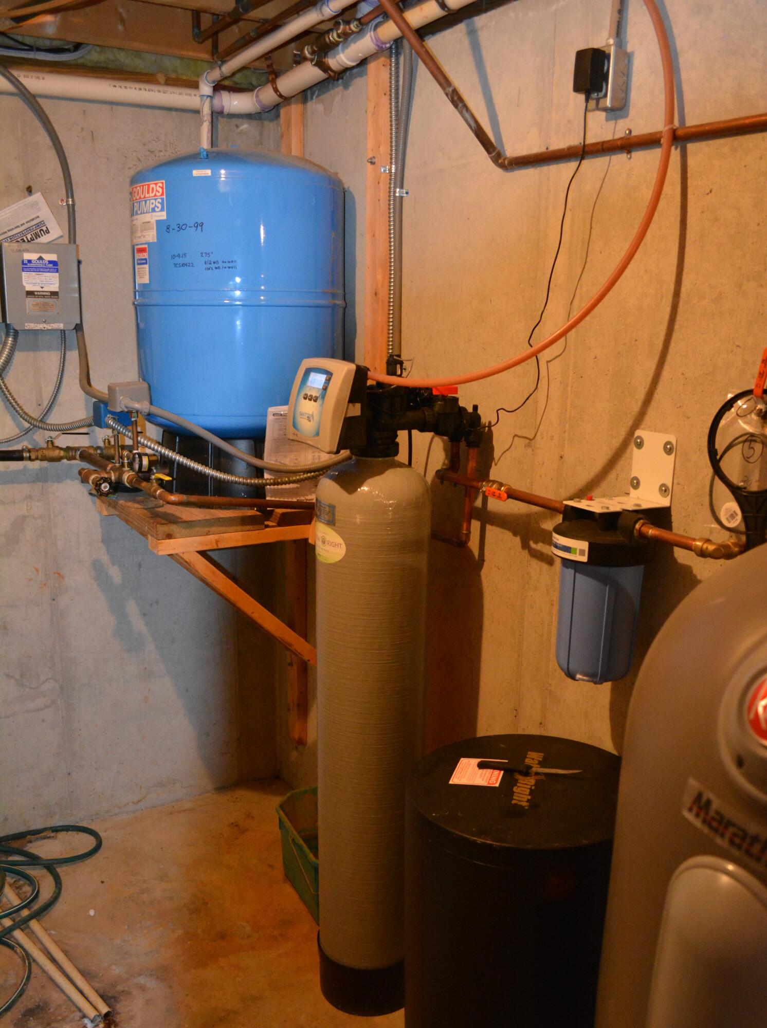 935 Adam Perry Road Rocky Mount, VA 24151 - Photo 21 of 24 a room with water heater and wooden cabinets