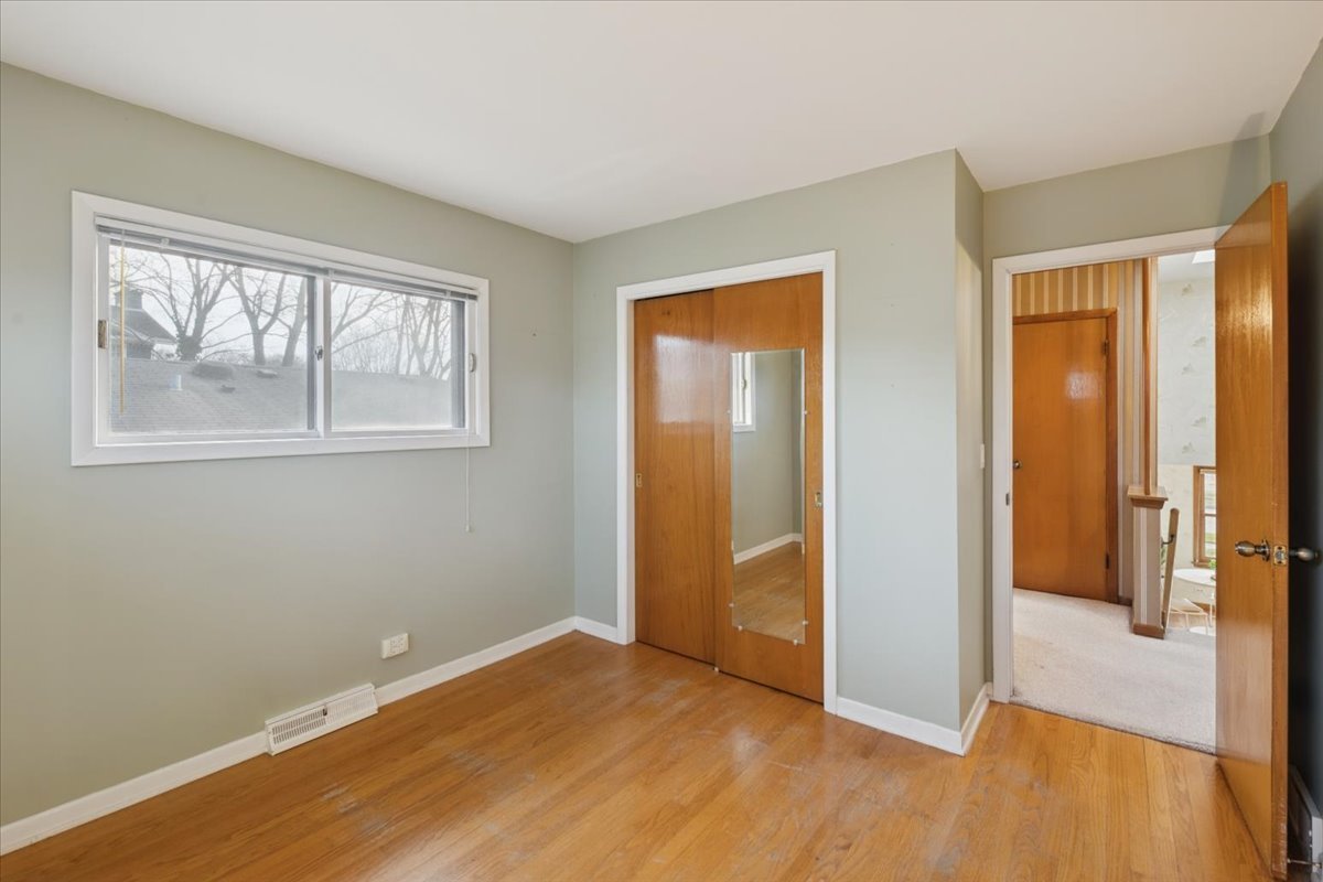 1814 Illinois Road Northbrook, IL 60062 - Photo 14 of 36 an empty room with wooden floor and windows