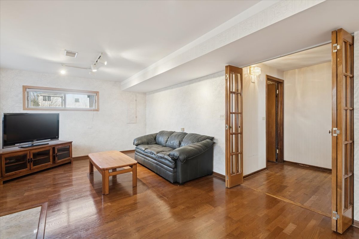 1814 Illinois Road Northbrook, IL 60062 - Photo 19 of 36 a living room with furniture and a flat screen tv