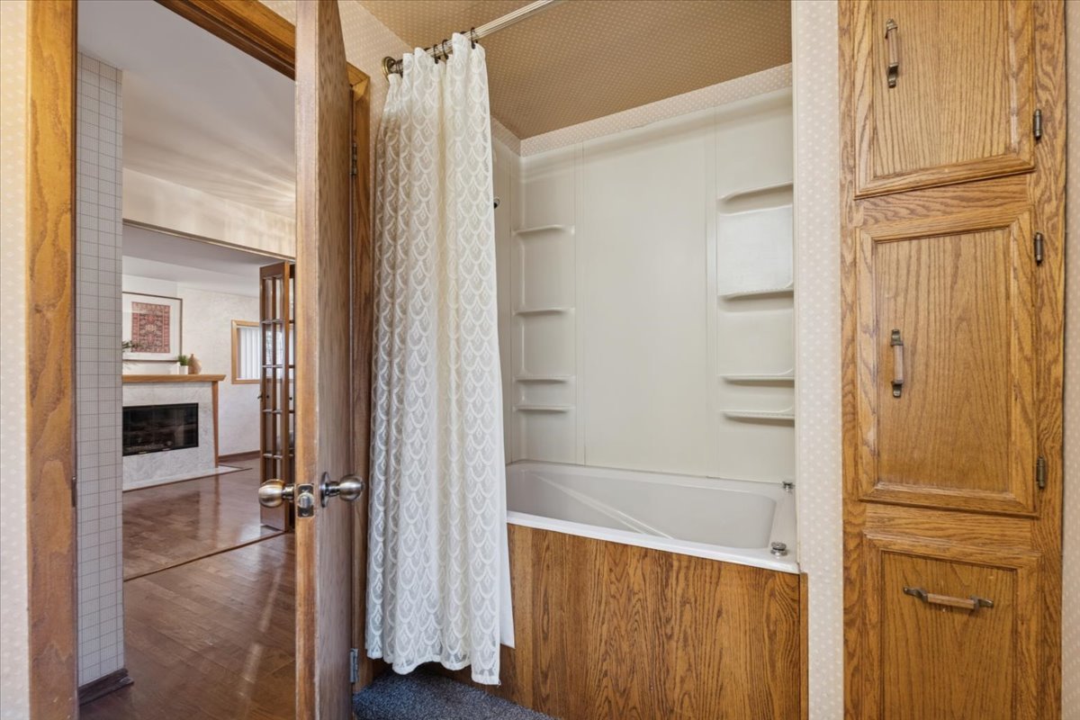 1814 Illinois Road Northbrook, IL 60062 - Photo 21 of 36 a bathroom with a shower and a glass door