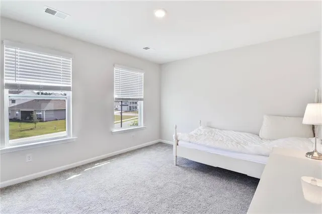 a spacious bedroom with a bed and a window