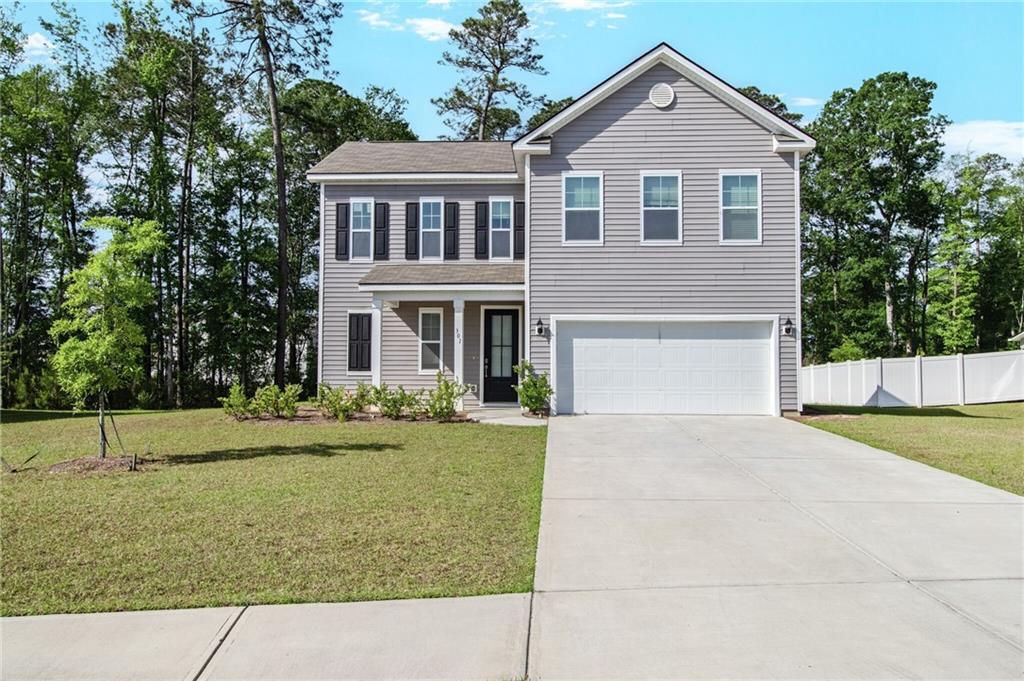 301 Merganser Drive Pooler, GA 31322 - Photo 18 of 18 a front view of a house with a yard and garage