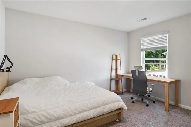 a bedroom with a bed a desk and chair