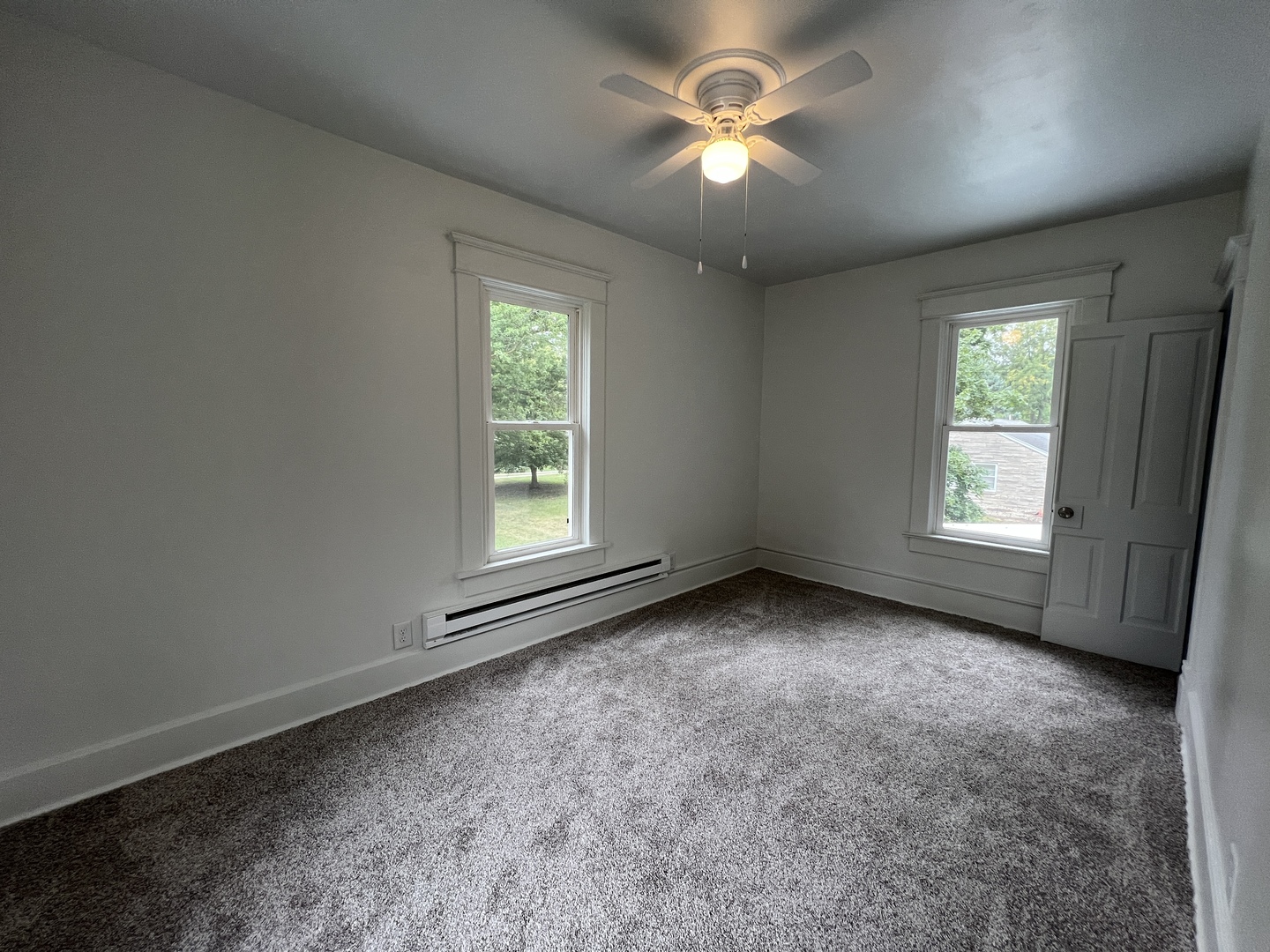 107 West Weldon Street Roberts, IL 60962 - Photo 18 of 21 an empty room with a window and a fan