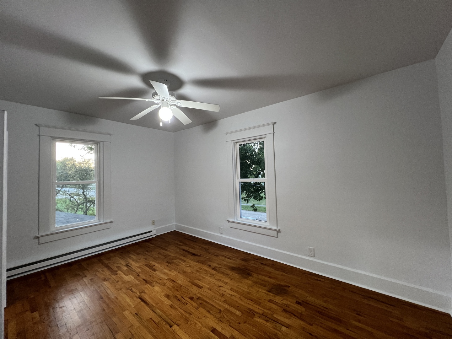 107 West Weldon Street Roberts, IL 60962 - Photo 19 of 21 an empty room with wooden floor chandelier and windows