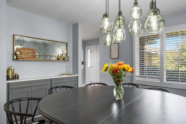 a view of a dining room with furniture and a chandelier