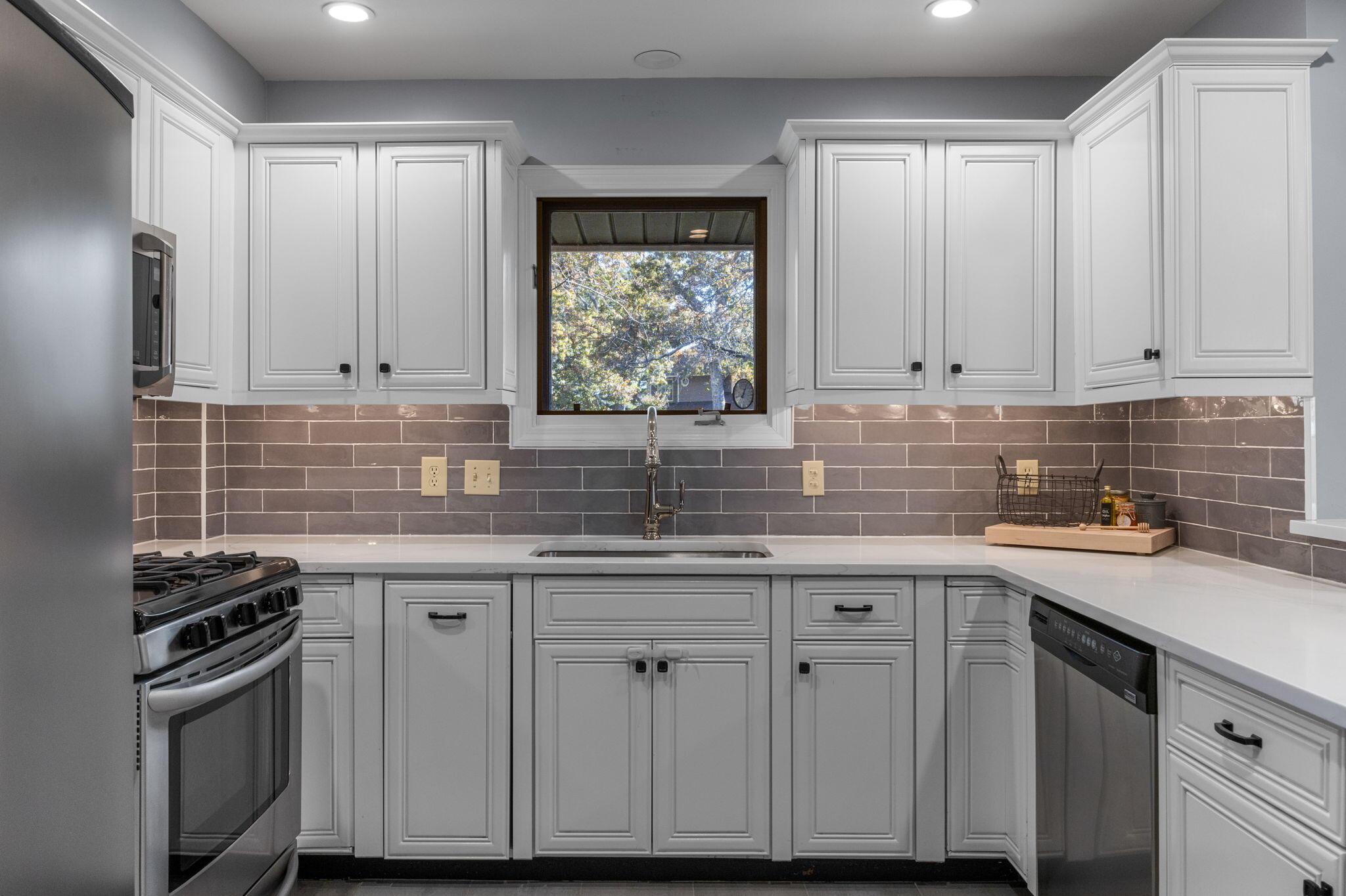 2 Dogwood Road, Unit 2 Buzzards Bay, MA 02532 - Photo 24 of 49 a kitchen with stainless steel appliances granite countertop a sink stove and cabinets