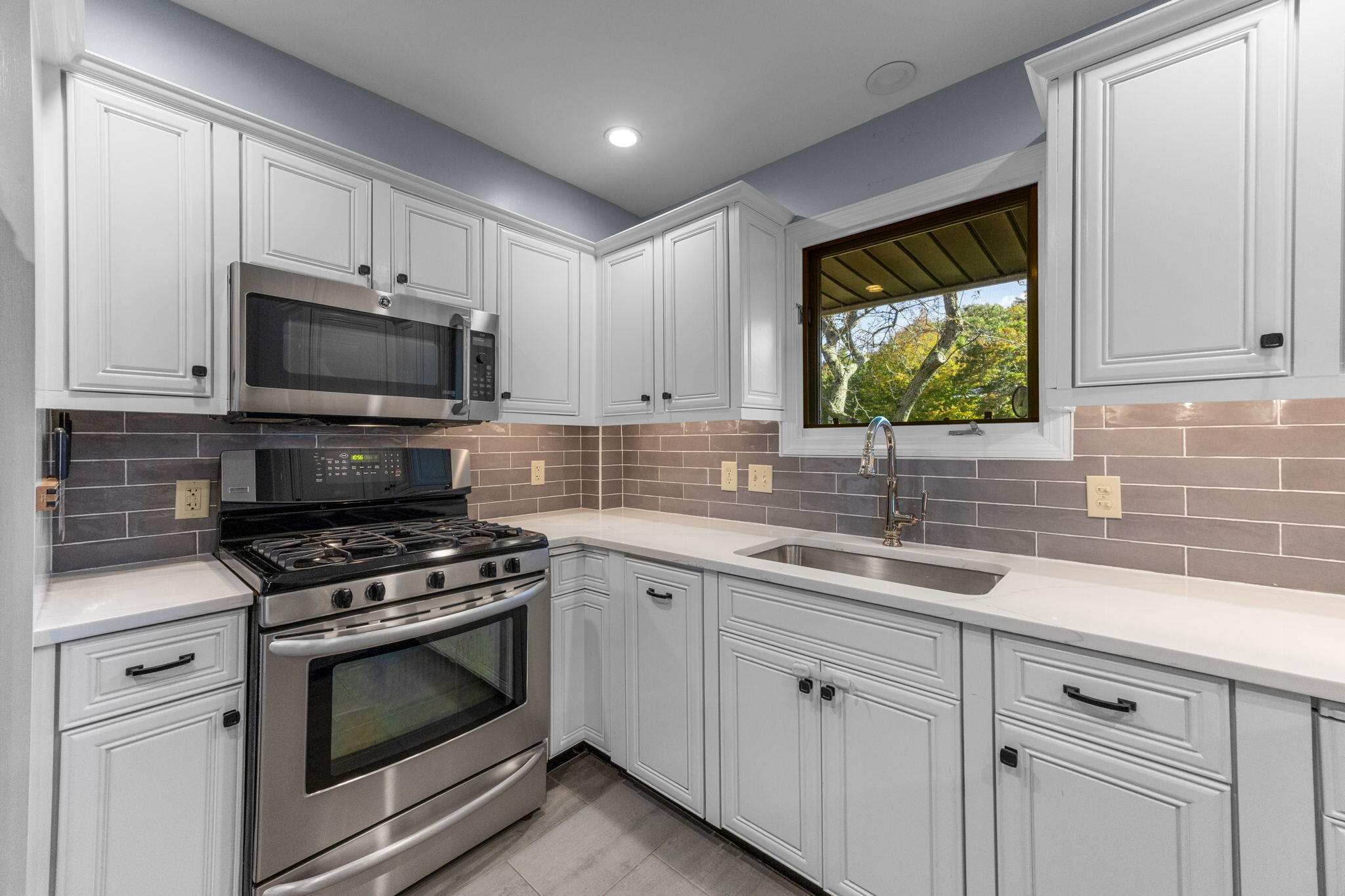 2 Dogwood Road, Unit 2 Buzzards Bay, MA 02532 - Photo 26 of 49 a kitchen with appliances a sink and cabinets
