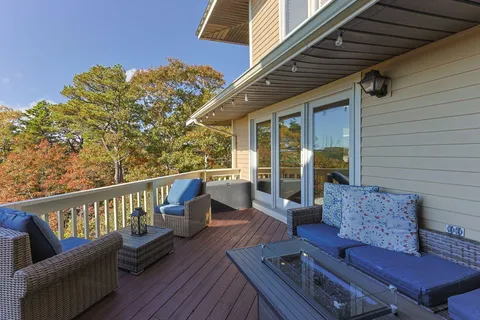 a view of roof deck with couches and wooden floor
