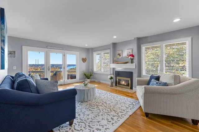 a living room with fireplace furniture and a fireplace