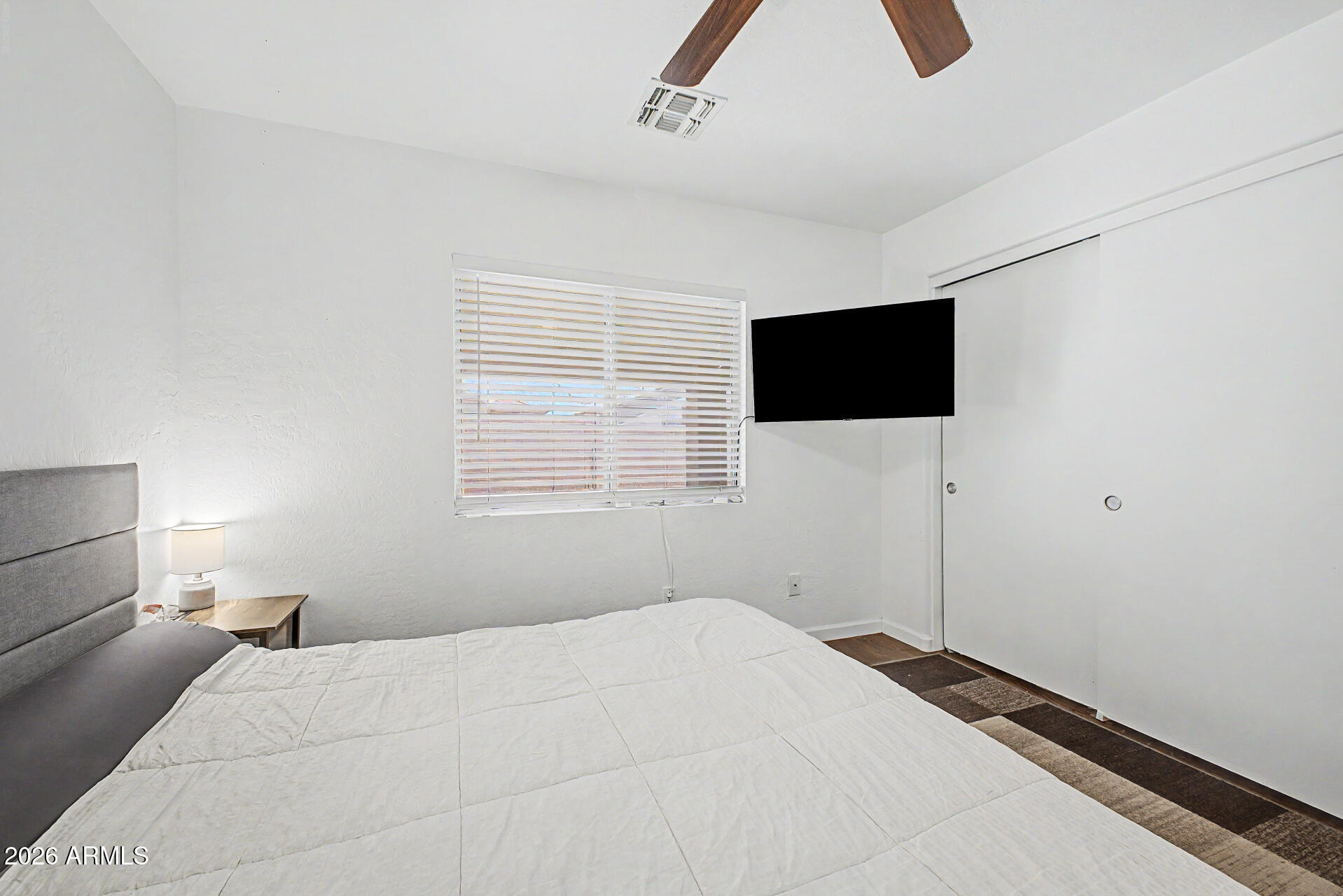 12008 West Larkspur Road El Mirage, AZ 85335 - Photo 13 of 25 a bedroom with a bed and a flat screen tv