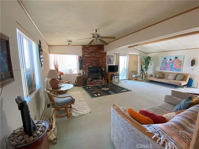 a living room with furniture rug and a fireplace