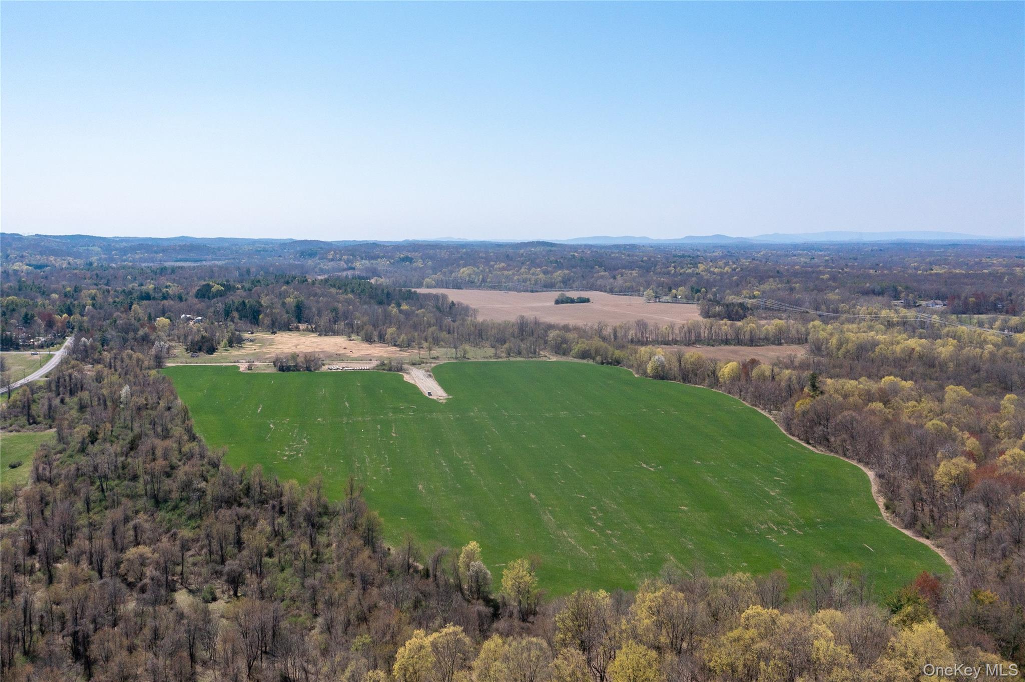 19 County Road Elizaville, NY 12523 - Photo 15 of 25 a view of a grassy area with mountains and a houses