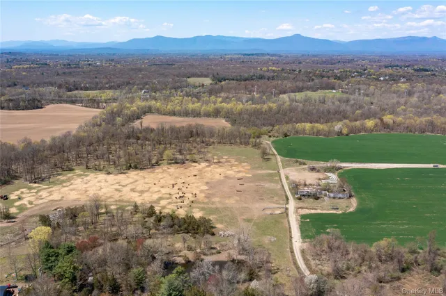 an aerial view of a house with a yard and lake view