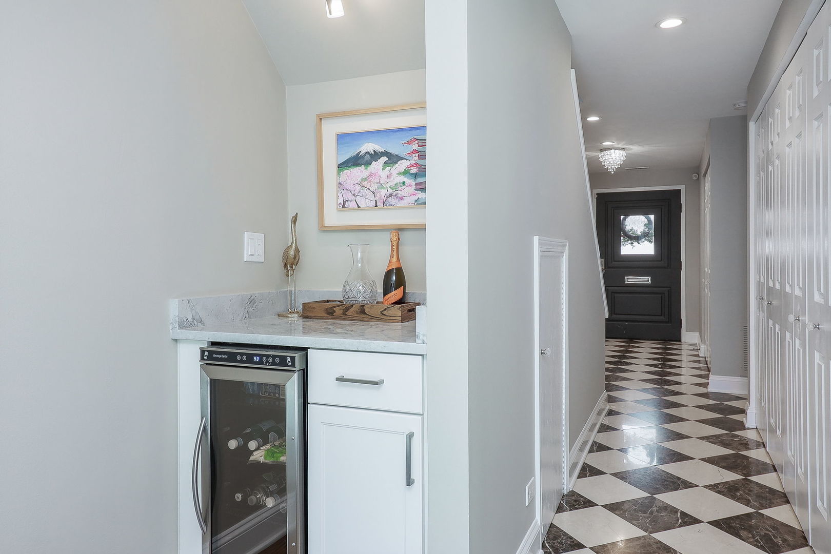 1346 North Sutton Place Chicago, IL 60610 - Photo 24 of 25 a hallway with front door and wooden floor