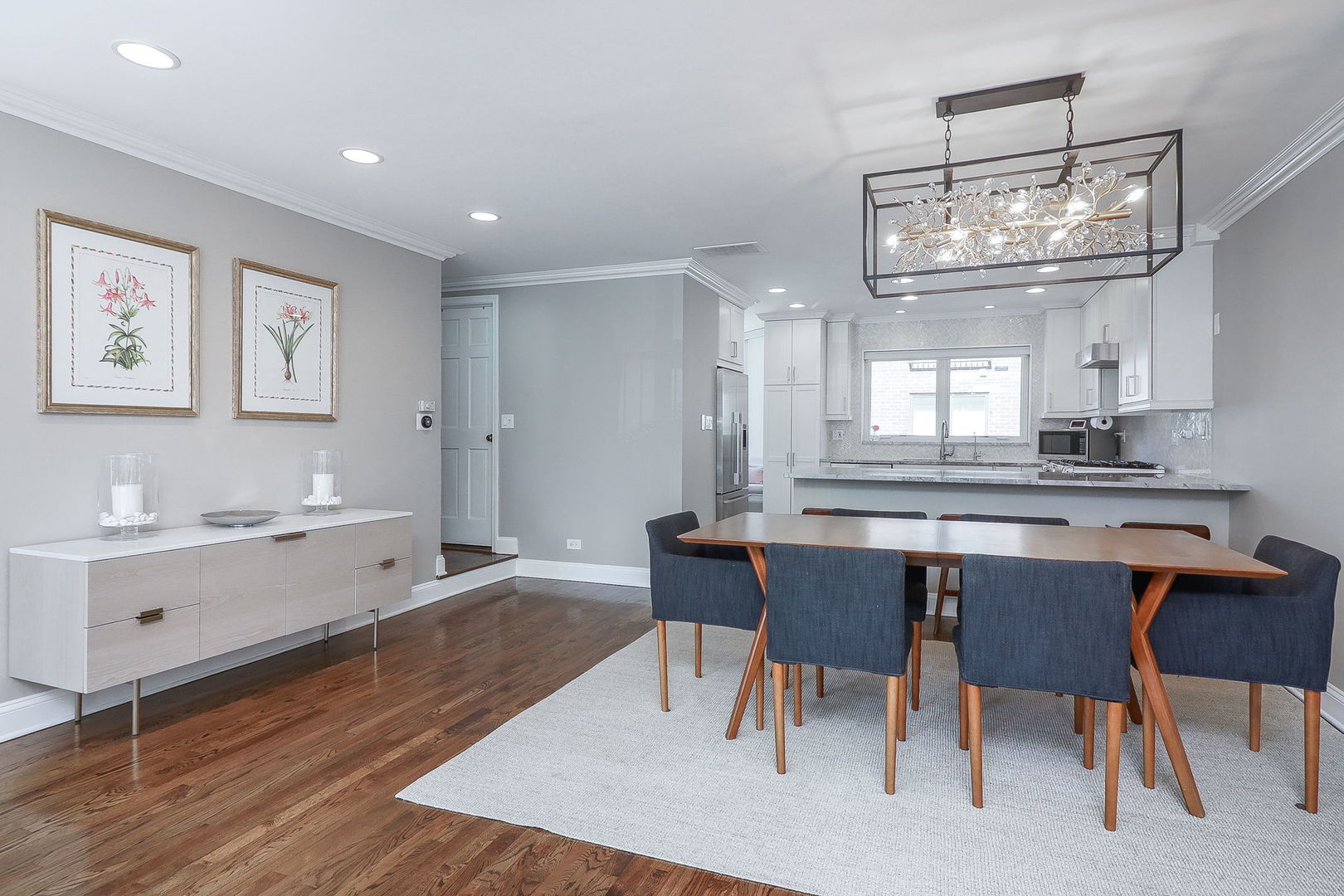 1346 North Sutton Place Chicago, IL 60610 - Photo 5 of 25 a kitchen with a dining table chairs cabinets and stainless steel appliances