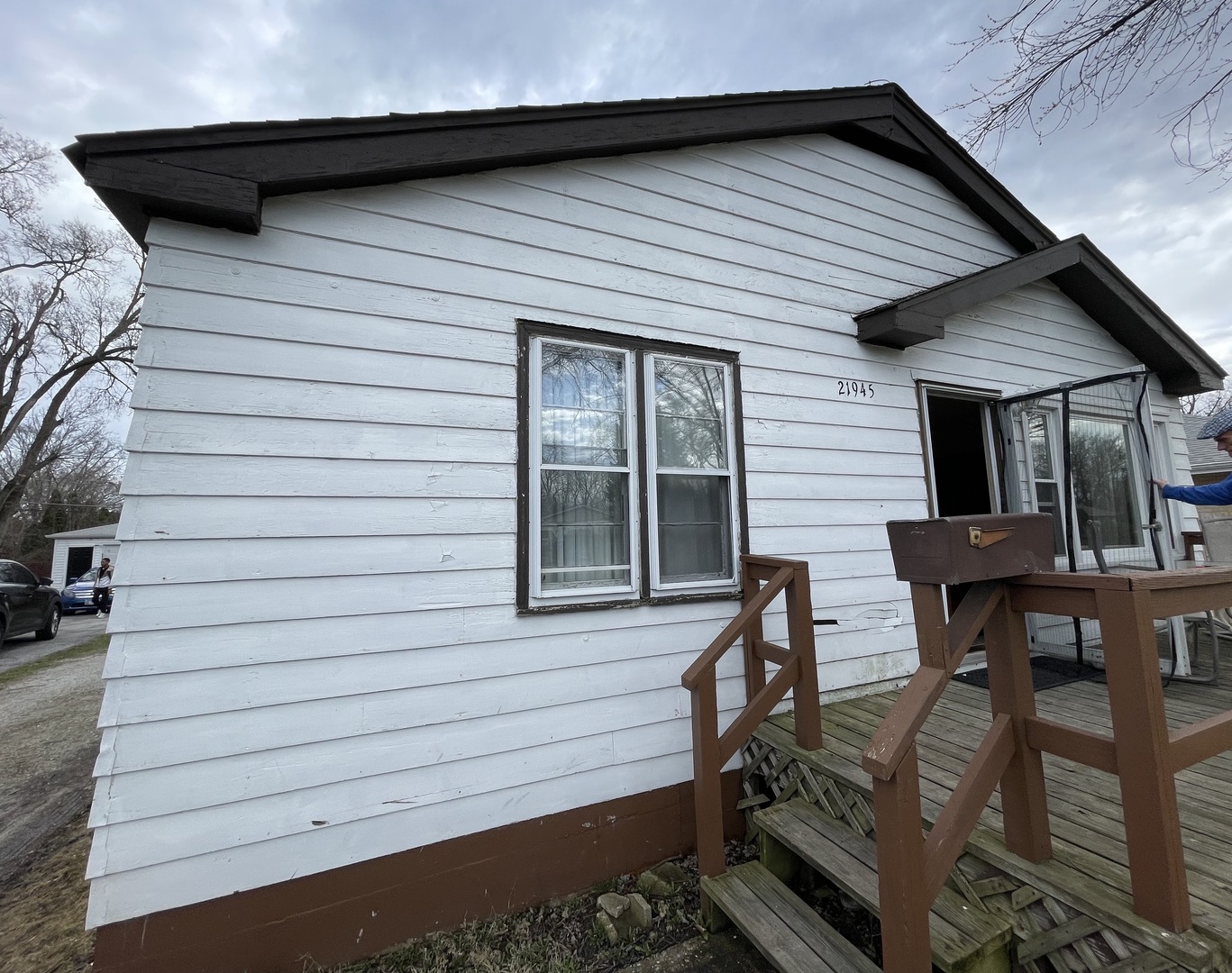 a view of backyard of house with seating space