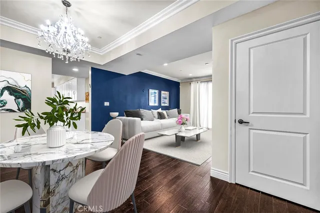 a view of a dining room with furniture wooden floor and chandelier
