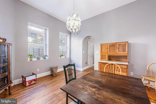 a living room with furniture a table and wooden floor